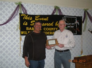 Perry receiving the certificate from Gene Van Eeckhout